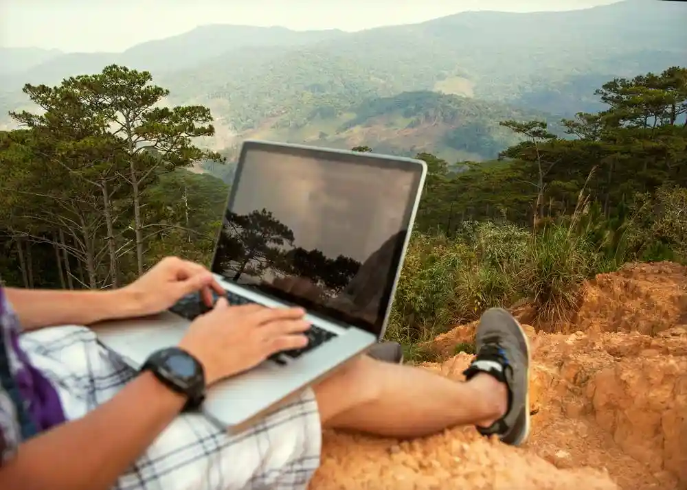 Laptop Travel Man with Laptop on Mountain