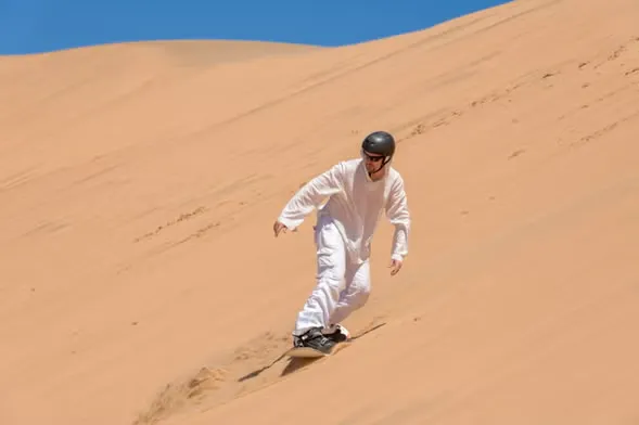Sandboarding down the world’s largest dunes
