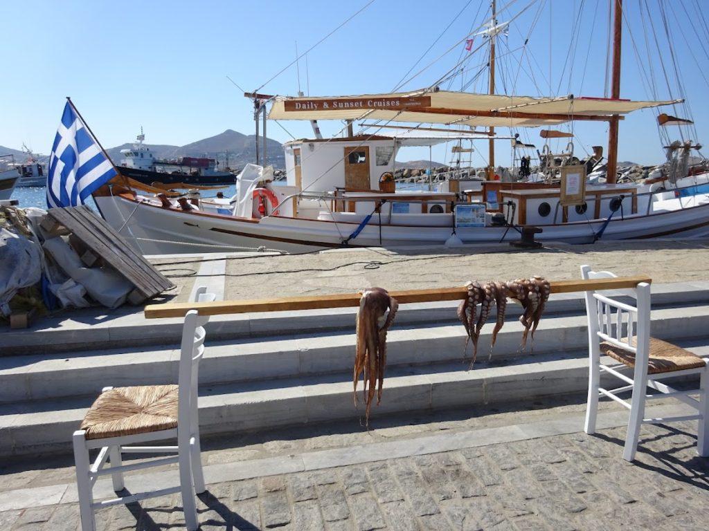 Octopus drying in the sun next to a fishing boat in Naoussa