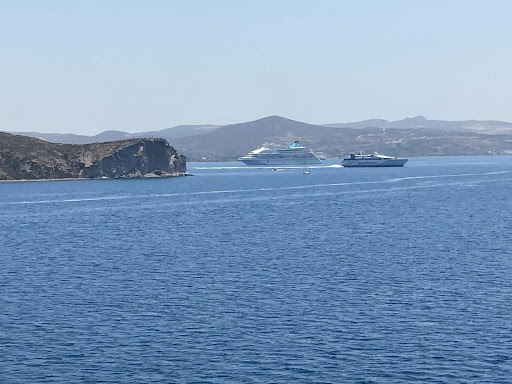 Looking out towards the port of Santorini with a cruise ship parked and a SeaJets ferry leaving