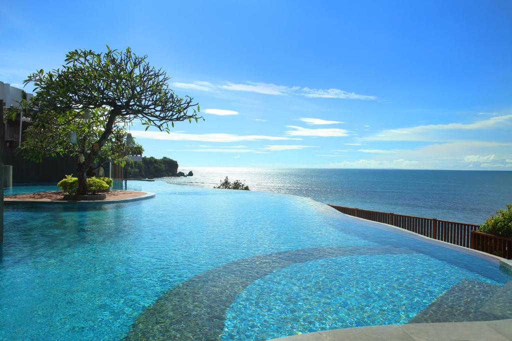 Infinity pool overlooking the ocean at Anantara Uluwatu Bali Resort featuring cliffside views, tropical surroundings, and luxury beachfront accommodation in Uluwatu.