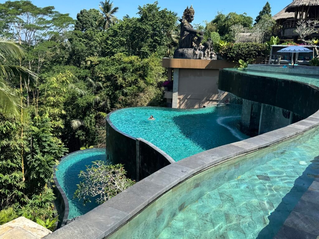 Best Honeymoon Resorts in Ubud - Tiered infinity pools at Kayon Jungle Resort in Ubud surrounded by lush tropical jungle and luxury Balinese villas.