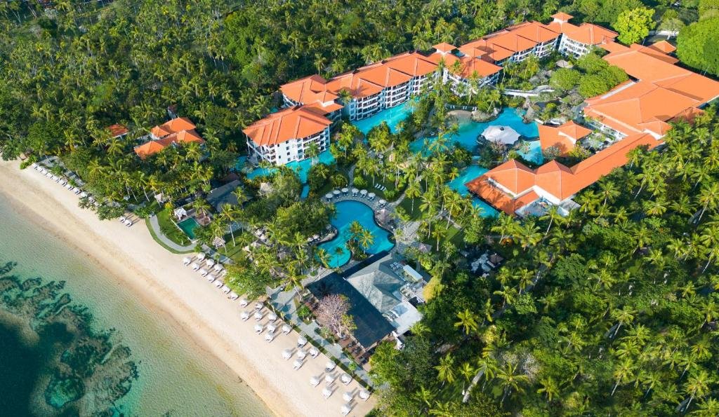 Best Honeymoon Resorts in Nusa Dua - Aerial view of The Laguna, a Luxury Collection Resort & Spa in Nusa Dua, Bali, showcasing beachfront luxury, tropical pools, palm-lined gardens, and a romantic coastal setting.