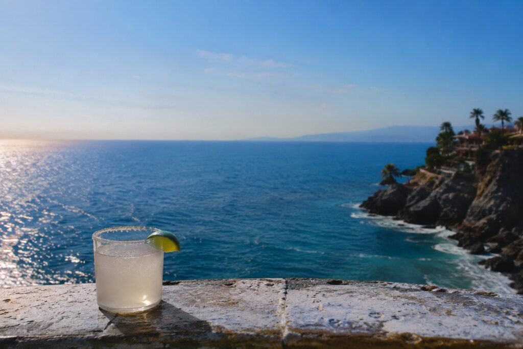 Mexico cliffside and ocean view with a margarita cocktail