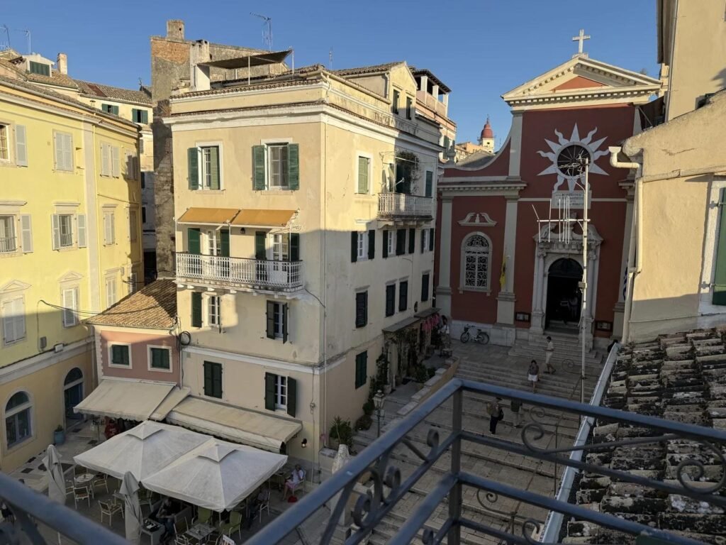 Balcony view from Kamara Old Town Studios overlooking the cathedral historic buildings and square in Corfu Old Town.